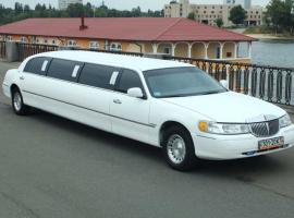 Stretched white limousine in Kyiv's riverbank